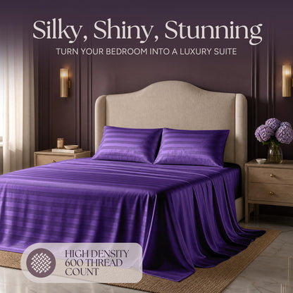 Purple striped satin bedding on an upholstered bed beneath "Silky, Shiny, Stunning", with a printed 600 thread count label.