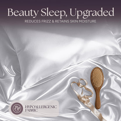 White satin pillow and rumpled fabric with a wooden hairbrush and ribbon beneath "Beauty Sleep, Upgraded".