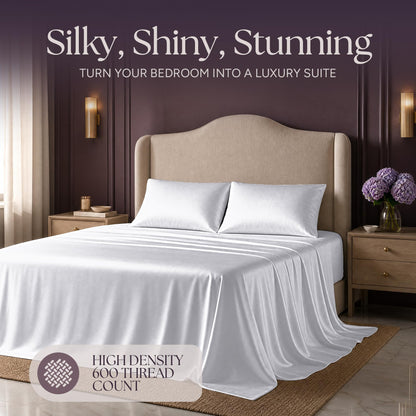 White satin bedding on an upholstered bed beneath "Silky, Shiny, Stunning", with a printed 600 thread count label.