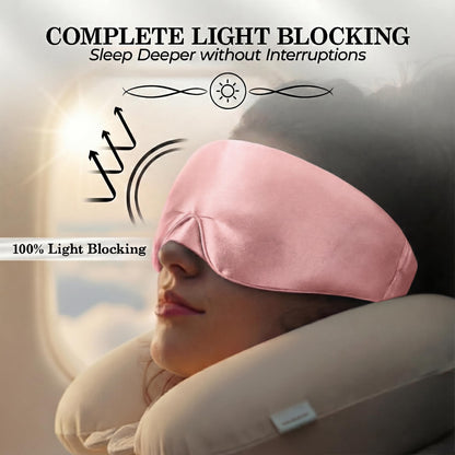 Person reclining with a neck pillow and pink wide sleep mask, with light reflection arrows beneath "Complete Light Blocking".