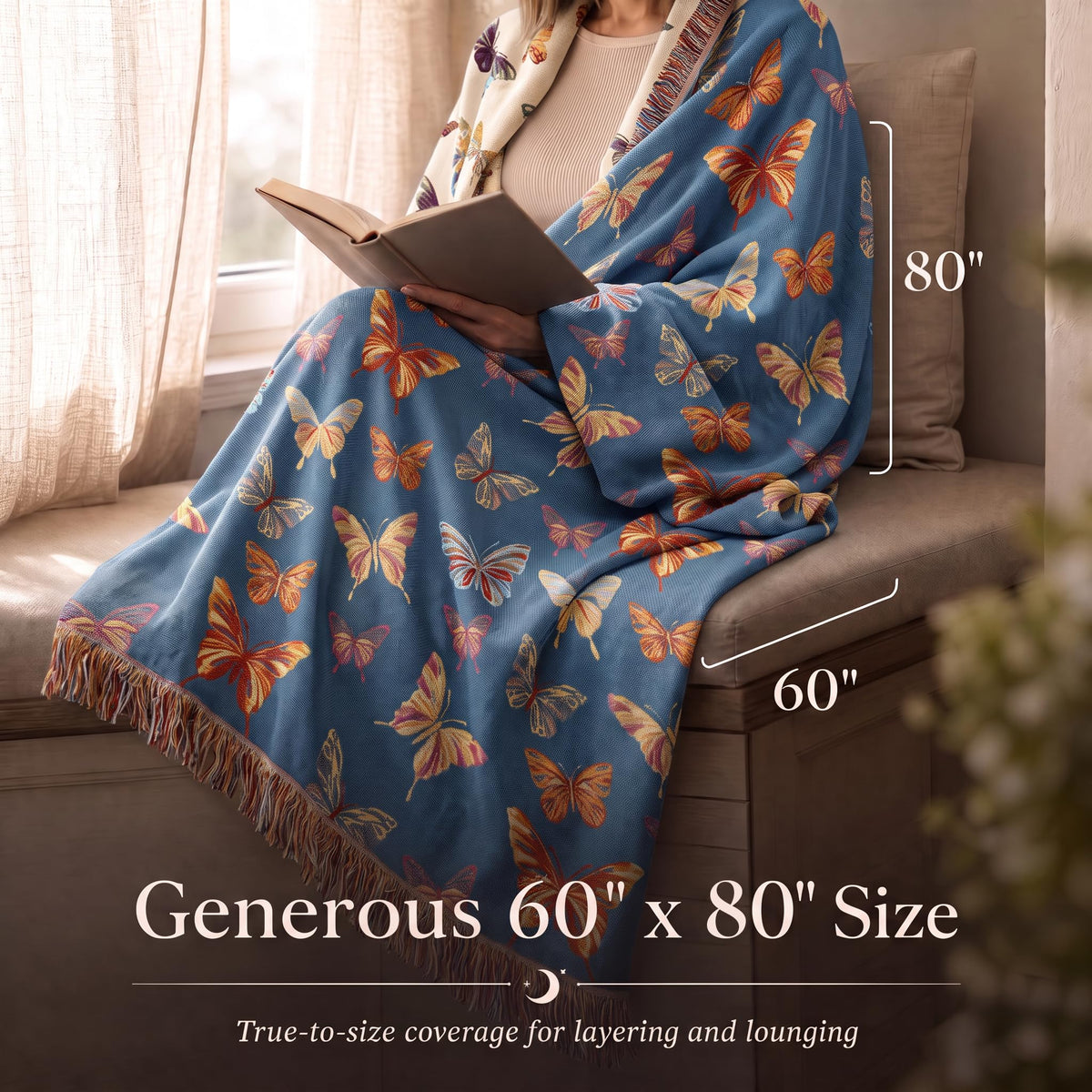 Person reading while wrapped in a blue butterfly patterned fringed throw, with size arrows labeled 60 by 80 inches.